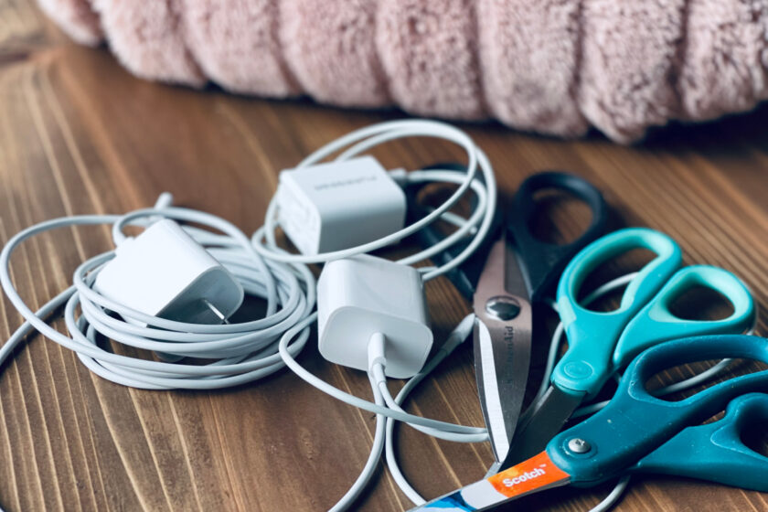 piles of chargers and scissors with throw blanket in background