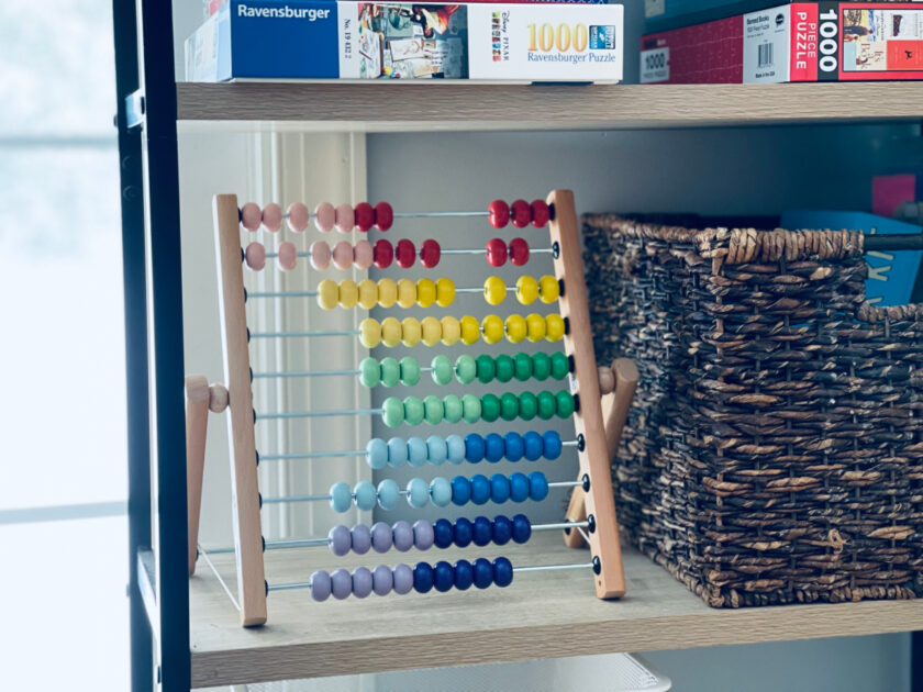 abacus and puzzles sitting on homeschool room shelf