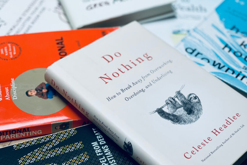 life-changing non-fiction books strewn on table, with Do Nothing book in focus