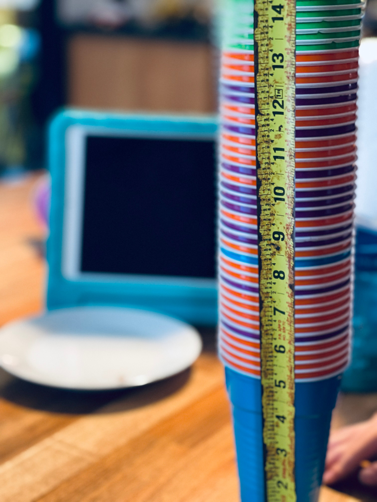 tape measure measuring stack on cups sitting on table