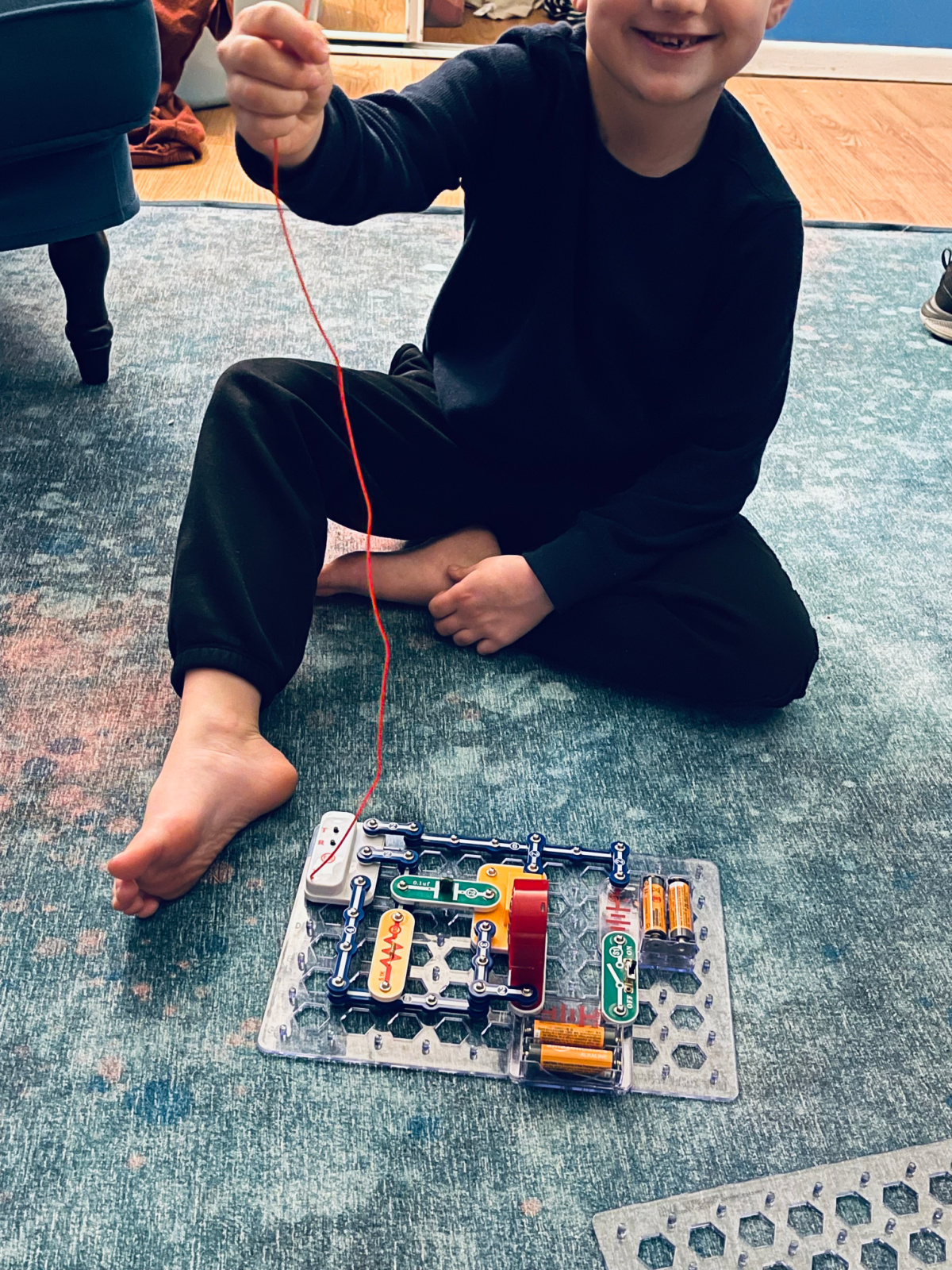 young boy showing off Snap Circuits creation.