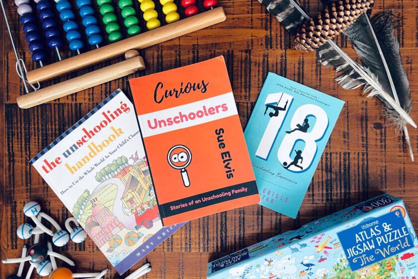 unschooling books and resources spread out on table.