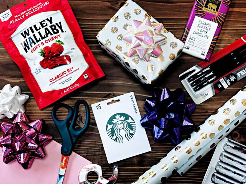 gifts for a minimalist woman spread out on table: licorice, chocolate, Starbucks gift card