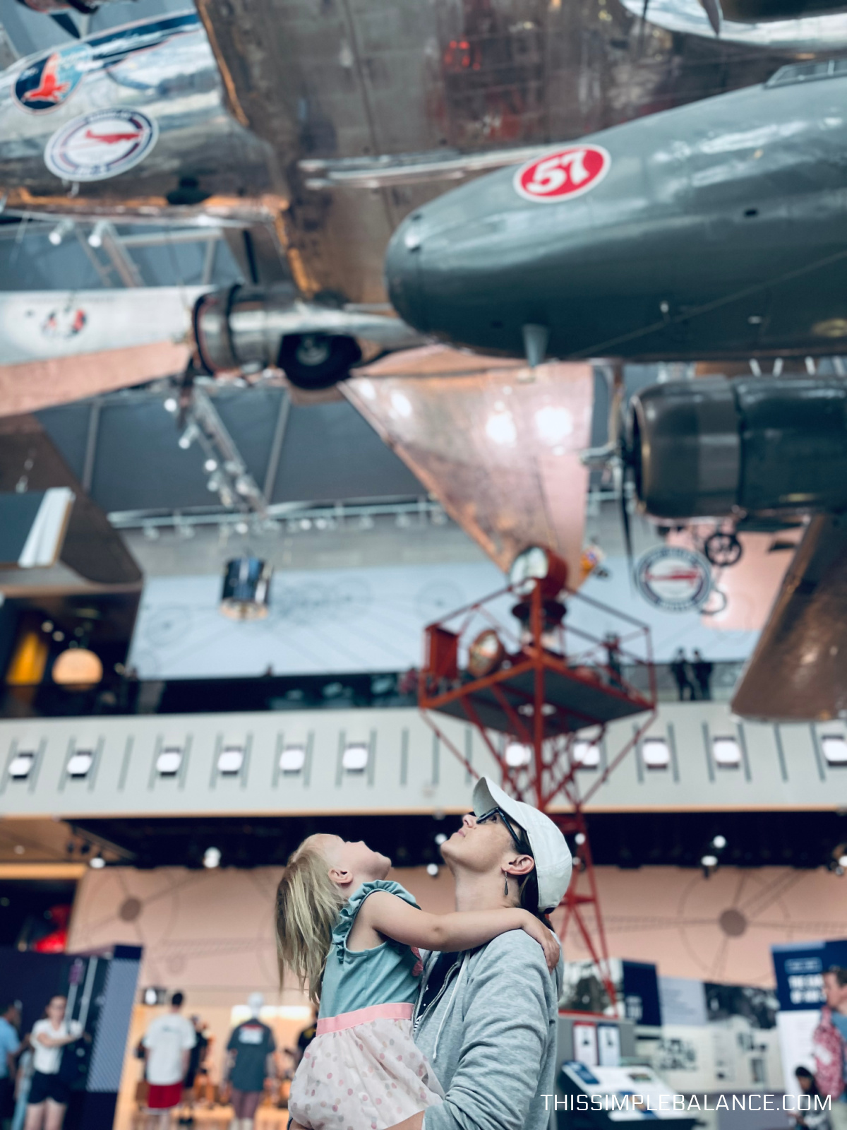 mom and young daughter looking up at the airplanes in the Air & Space Museum in Washington, D.C.