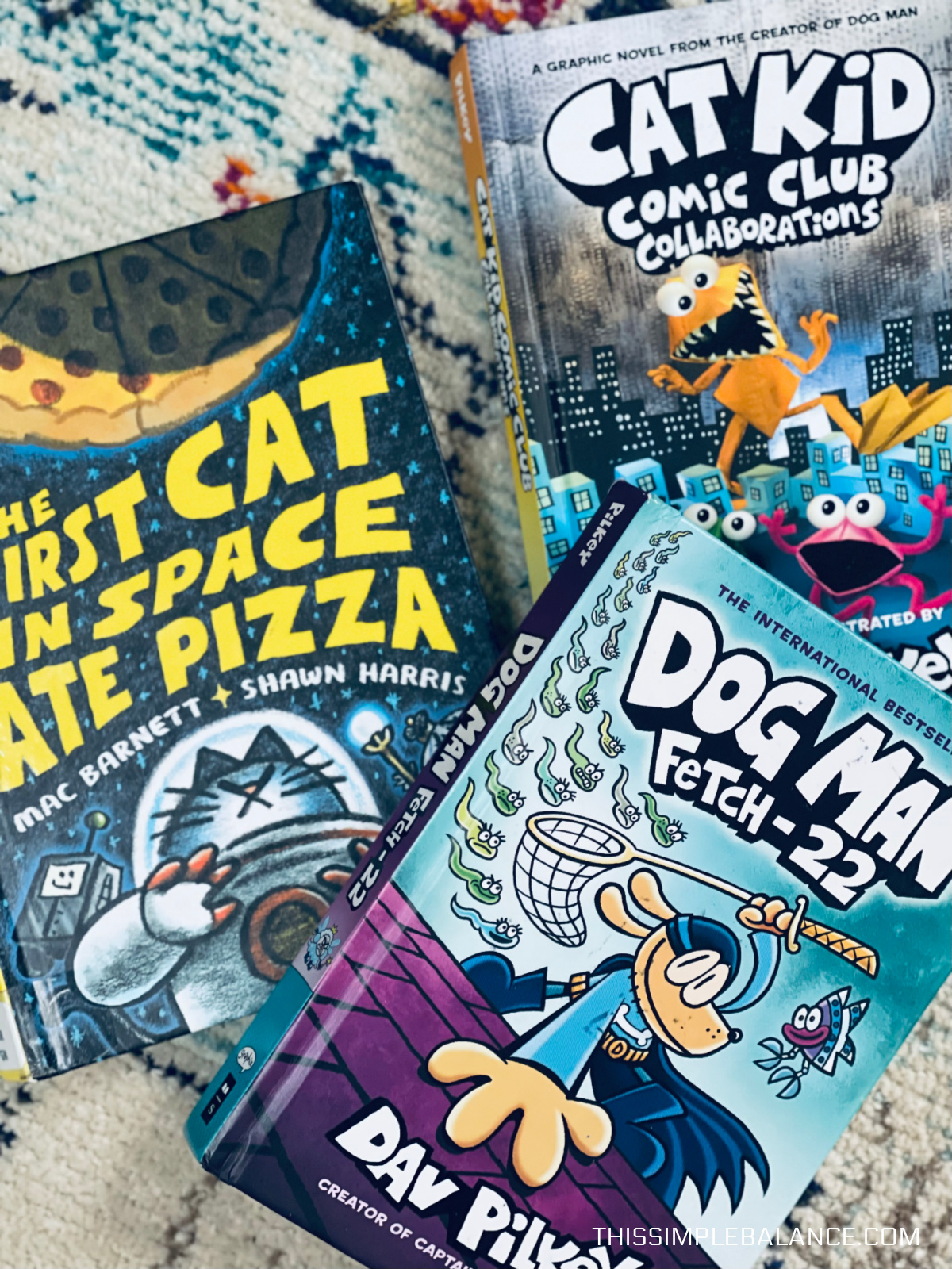 Dog Man book, Cat Kid Comic Club book and The First Cat in Space Ate Pizza book.