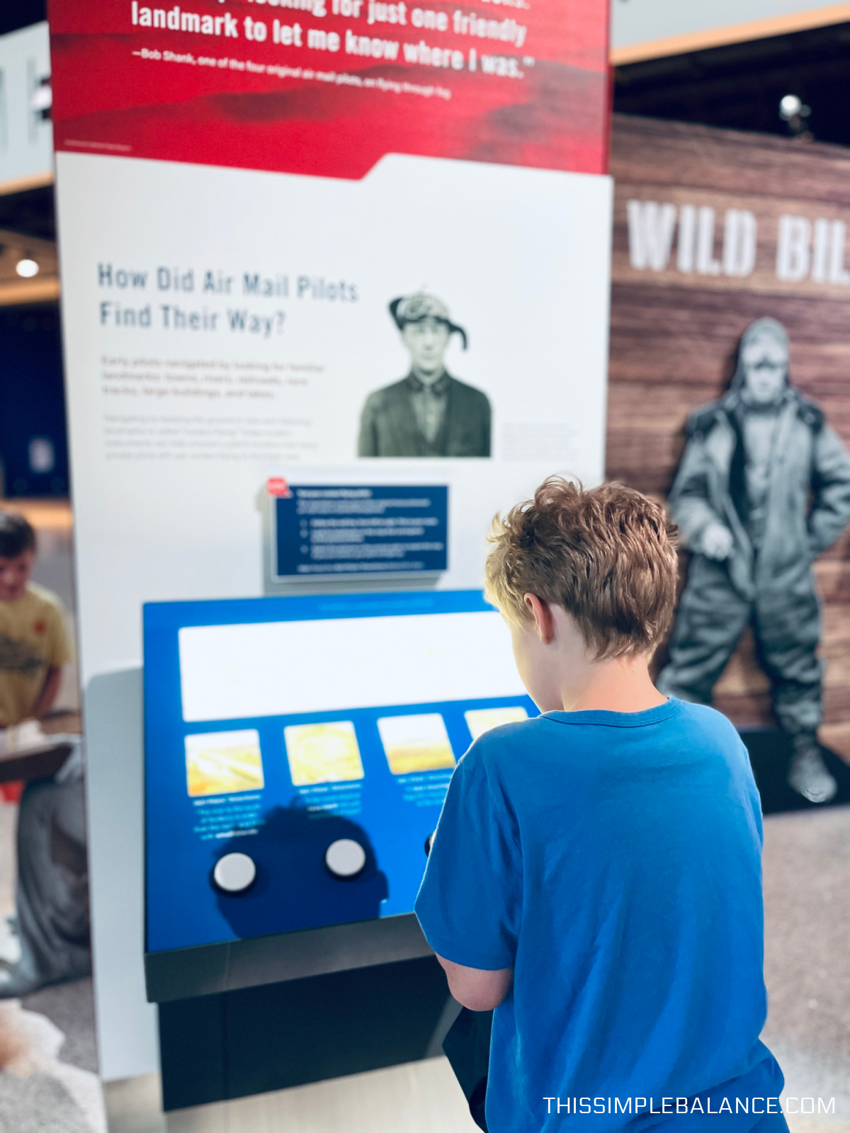 older child looking at Air & Space museum exhibit.