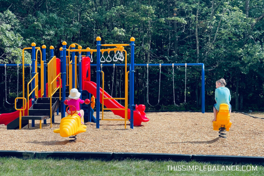 two unschooled siblings playing at a local park in the summertime