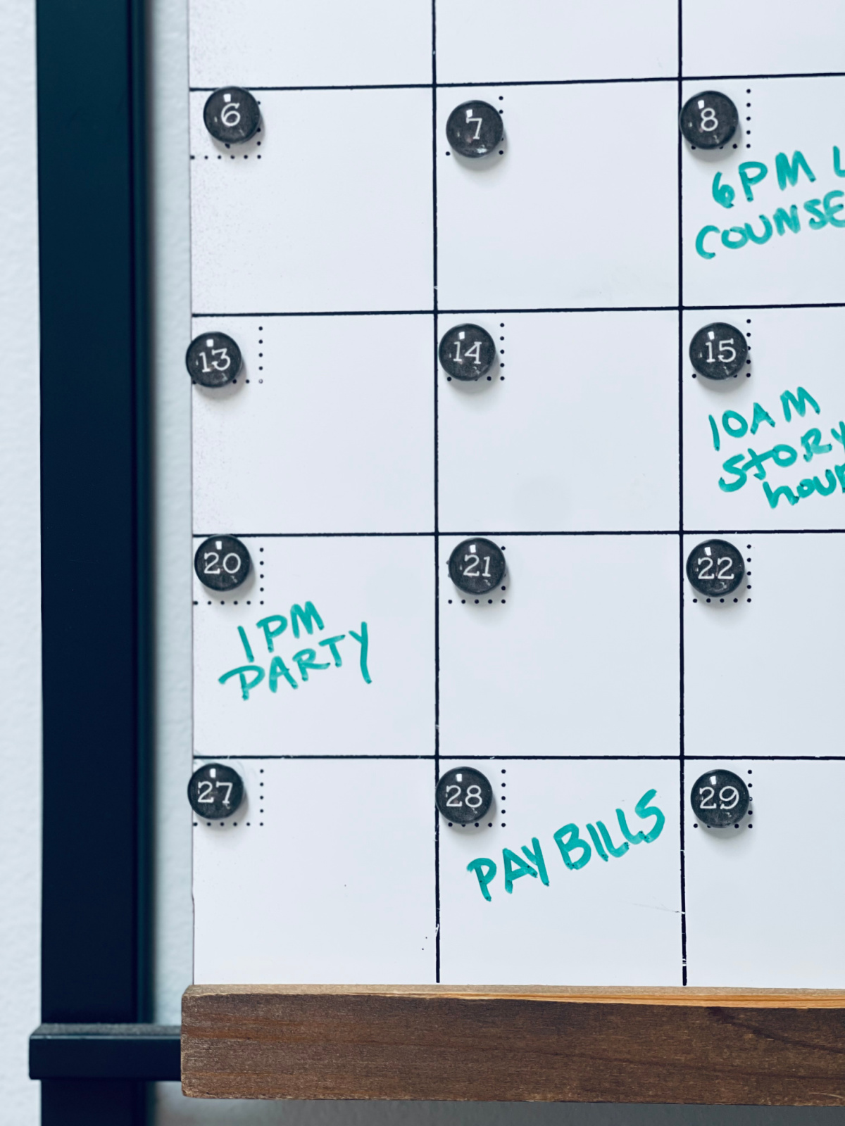 close-up of wall calendar with "pay bills" on the 28th.