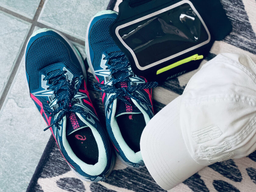 running shoes, phone carrier and baseball cap on floor, ready for a run.