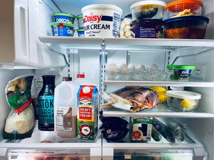 refrigerator full of fruit, yogurt vegetables, eggs and more.