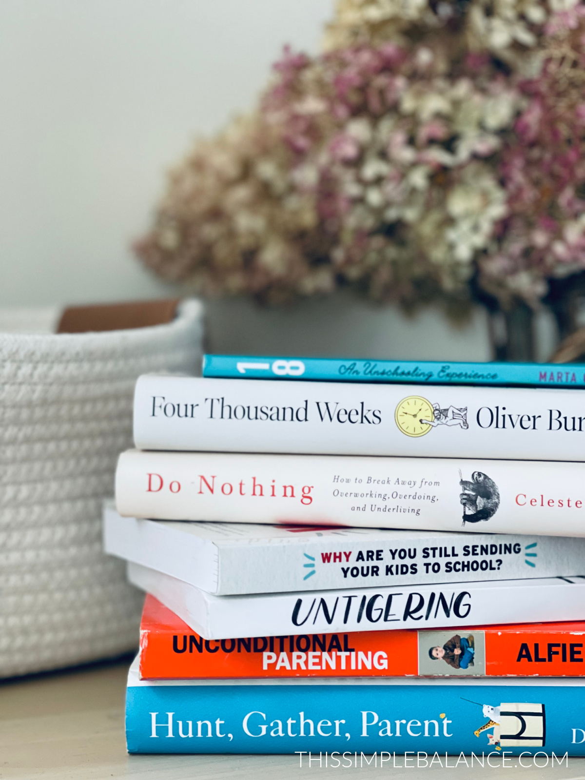 stack of respectful parenting and unschooling books.