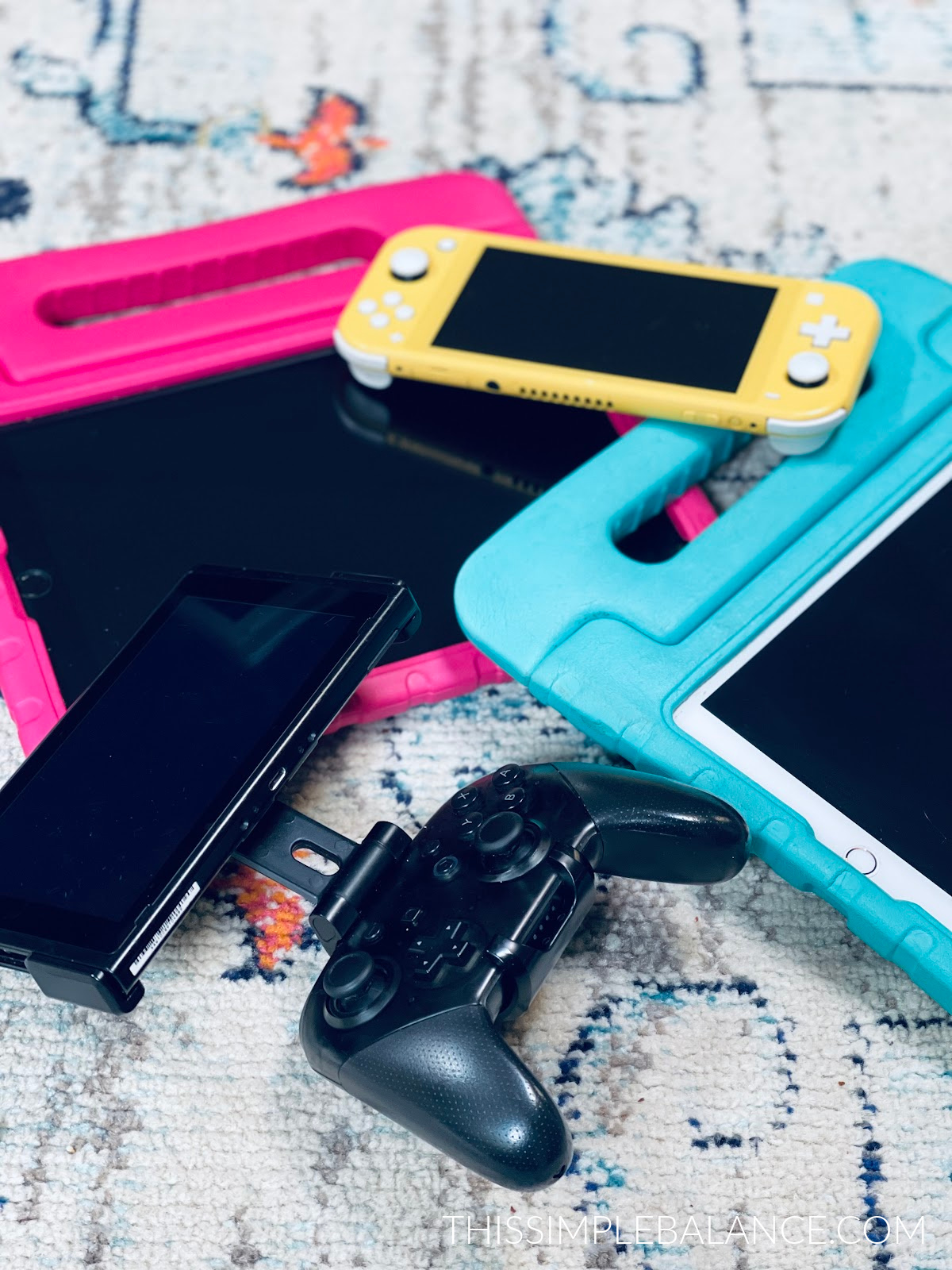 ipads and nintendo switch devices on carpet.