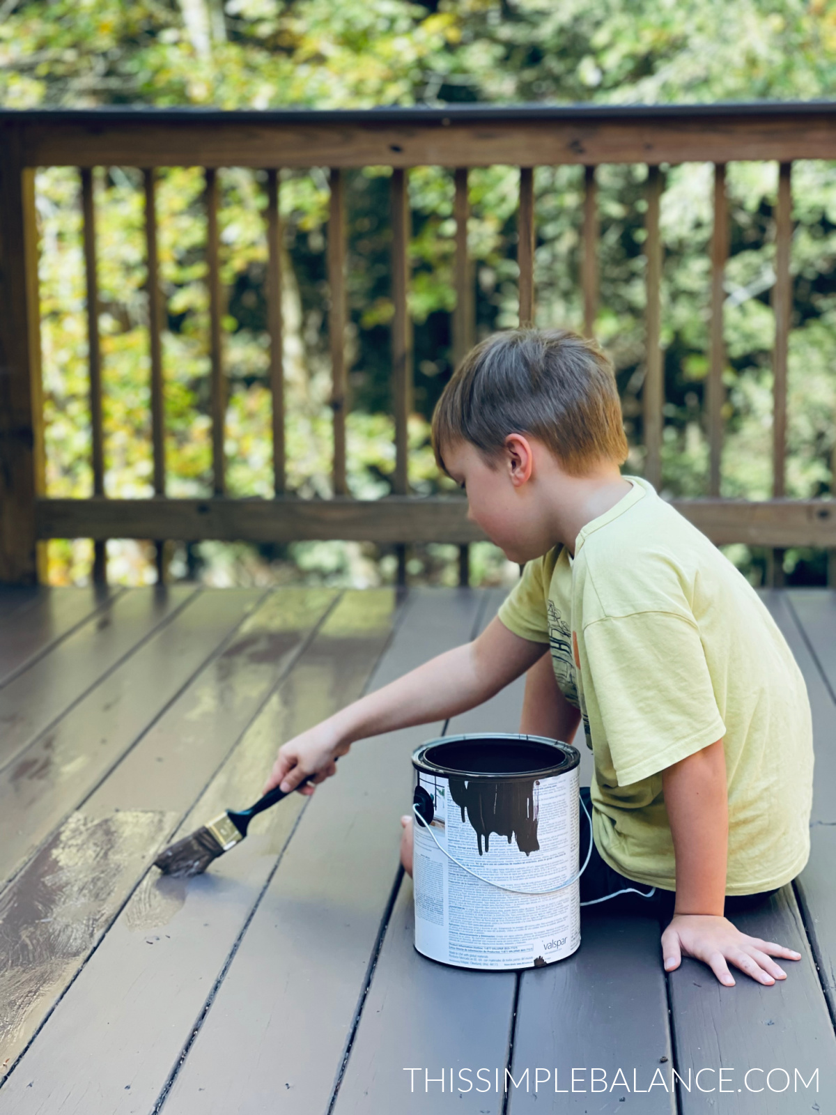child painting deck instead of watching screens.