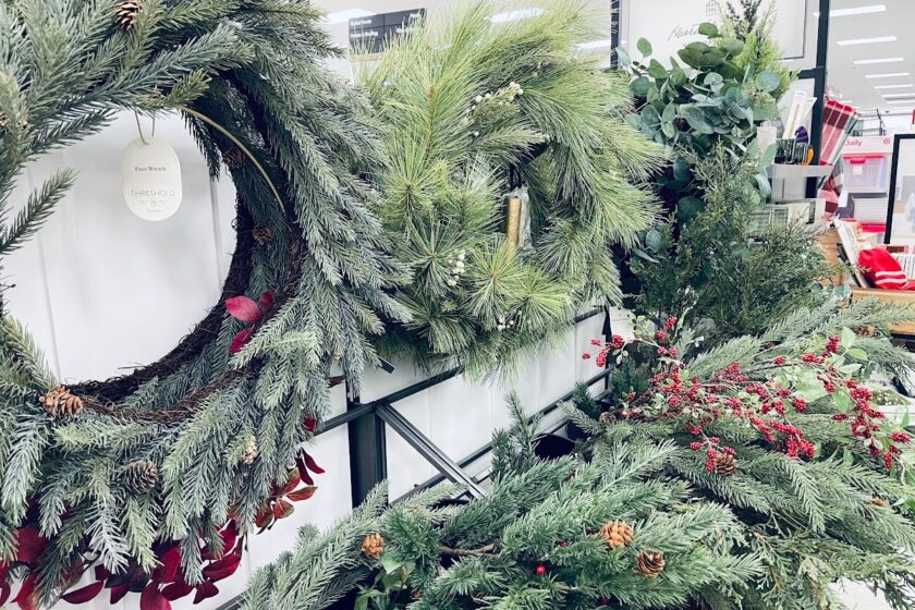 Christmas wreaths and greenery hanging in store.