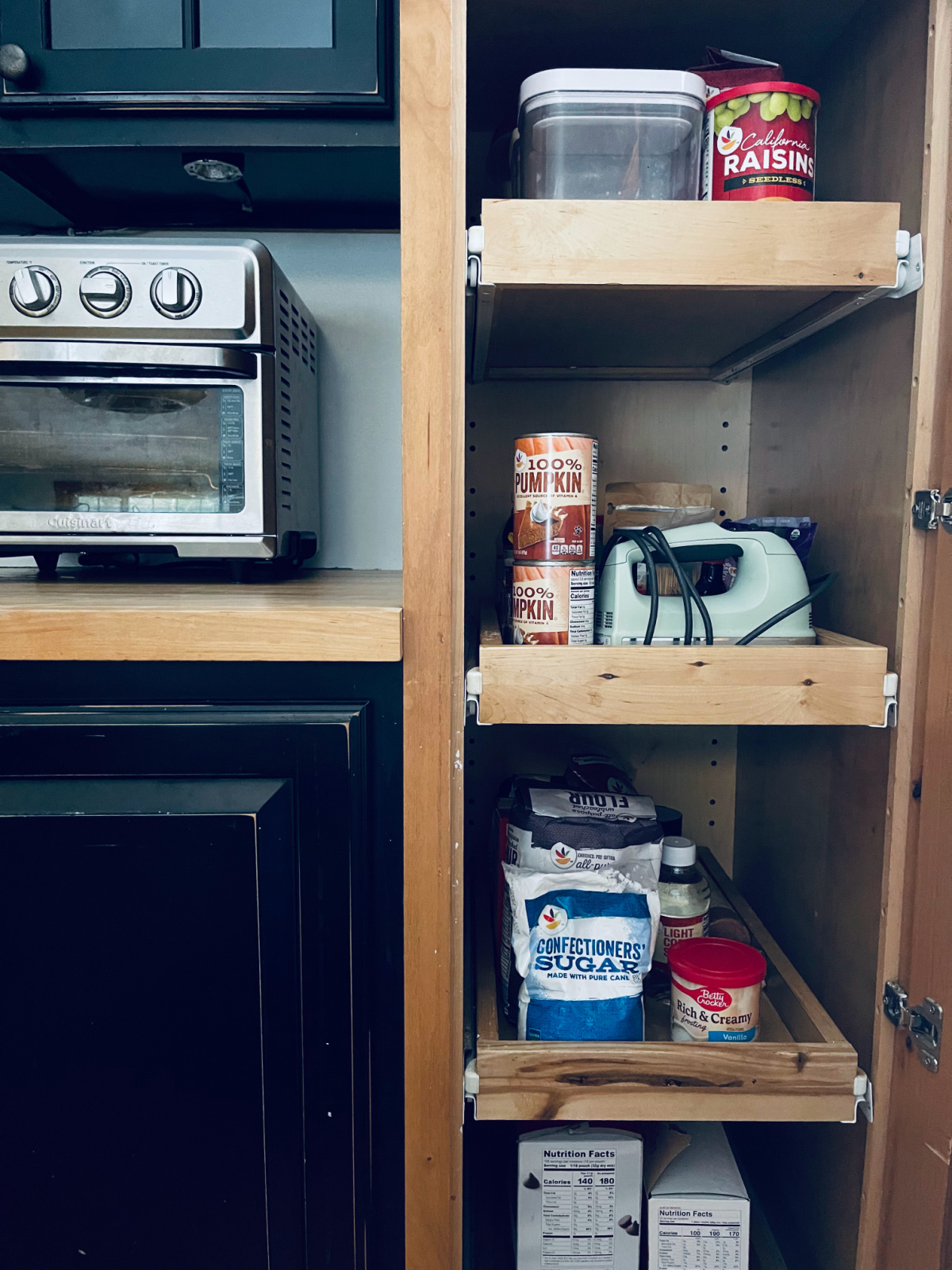 baking pantry items like flour, pumpkin and raisins on pull-out shelves.