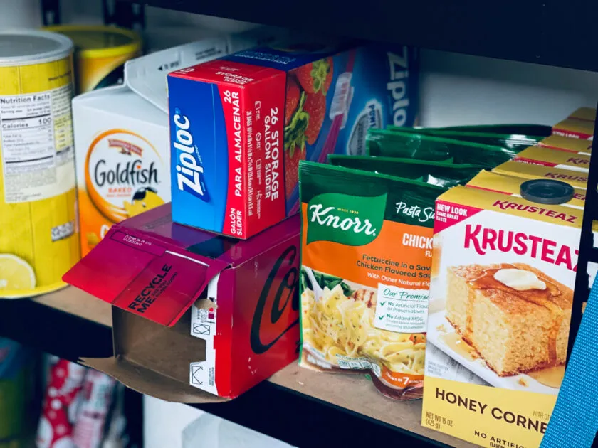 pasta sides, cornbread, ziplocs and goldfish in on a basement pantry shelf.