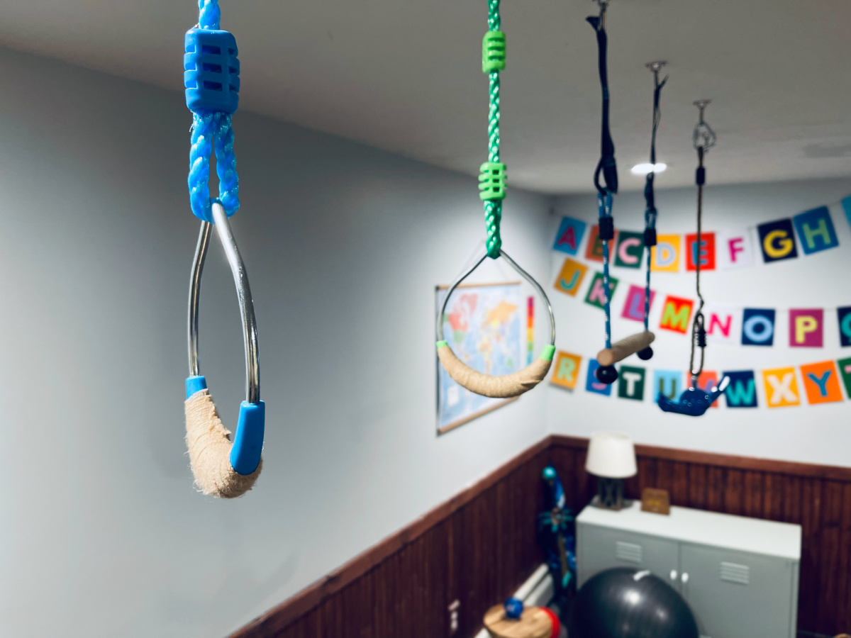 ninja rings and monkey bars hanging in playroom.