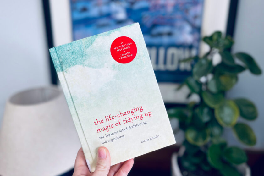 Marie Kondo's the life changing magic of tidying up book with plant and picture in background