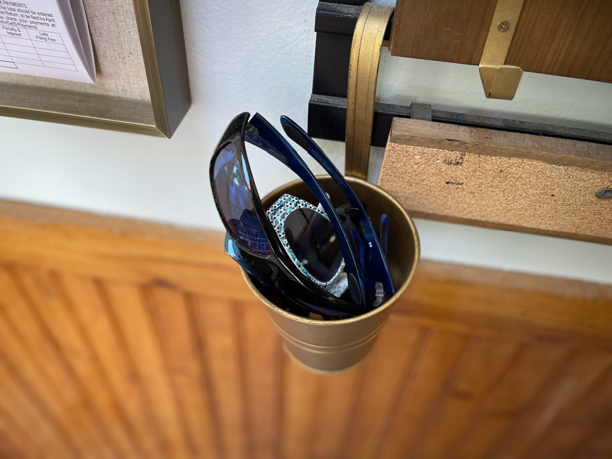 hanging gold cup filled with sunglasses.