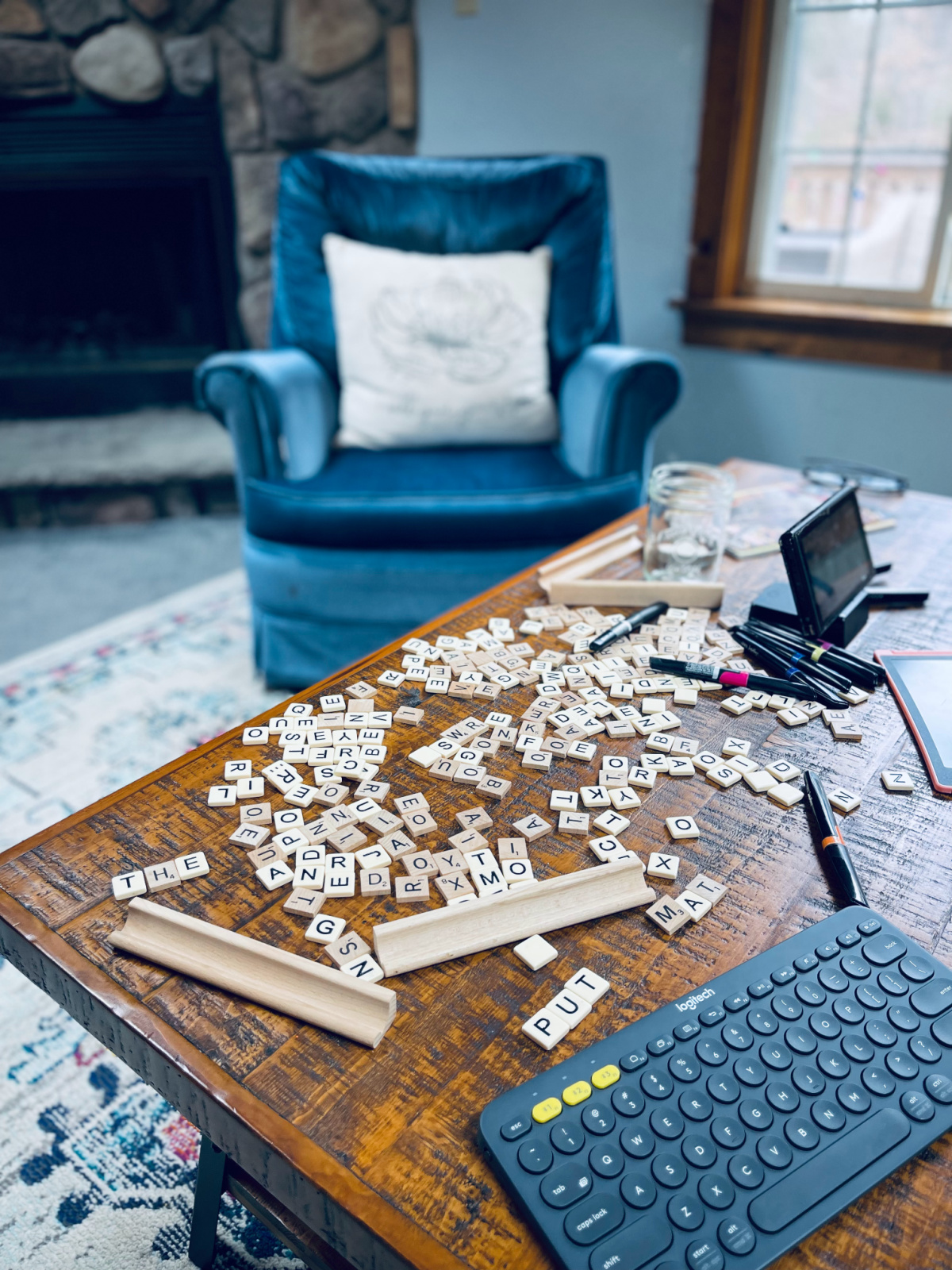 scrabble and bananagrams tiles strewn on coffee table.