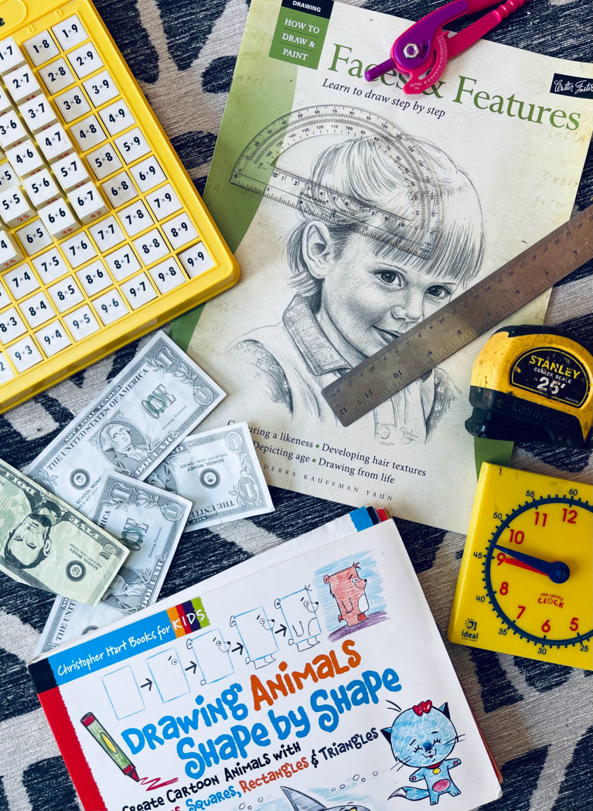 a variety of math manipulatives spread out on a rug.