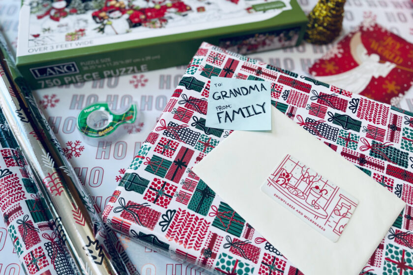 wrapped christmas gift with sticky note reading, "To Grandma, From Family"