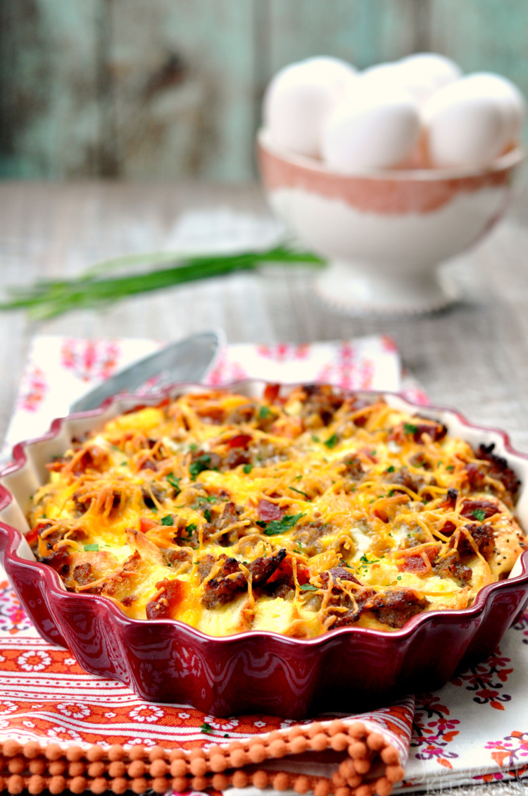 Meat and egg casserole in pie plate on red gingham napkin.