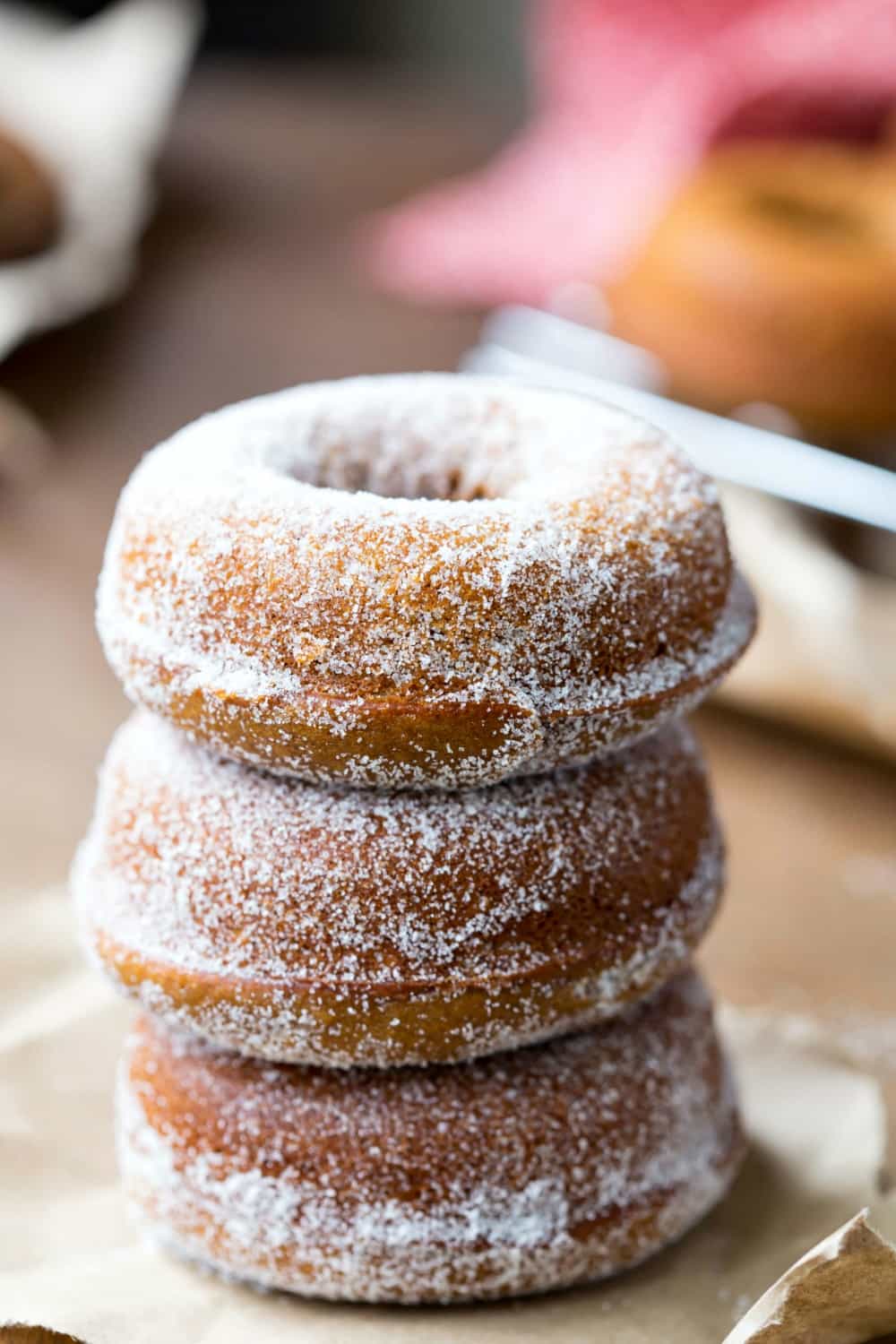 gingerbread donuts coated with white sugar and stacked.