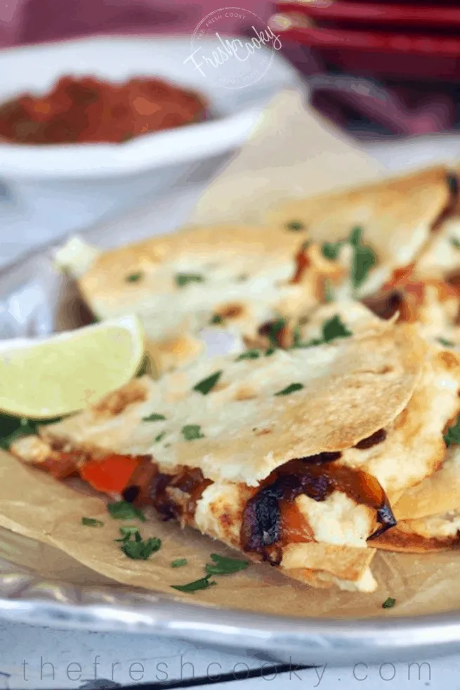 baked chicken quesadillas slices with lime.