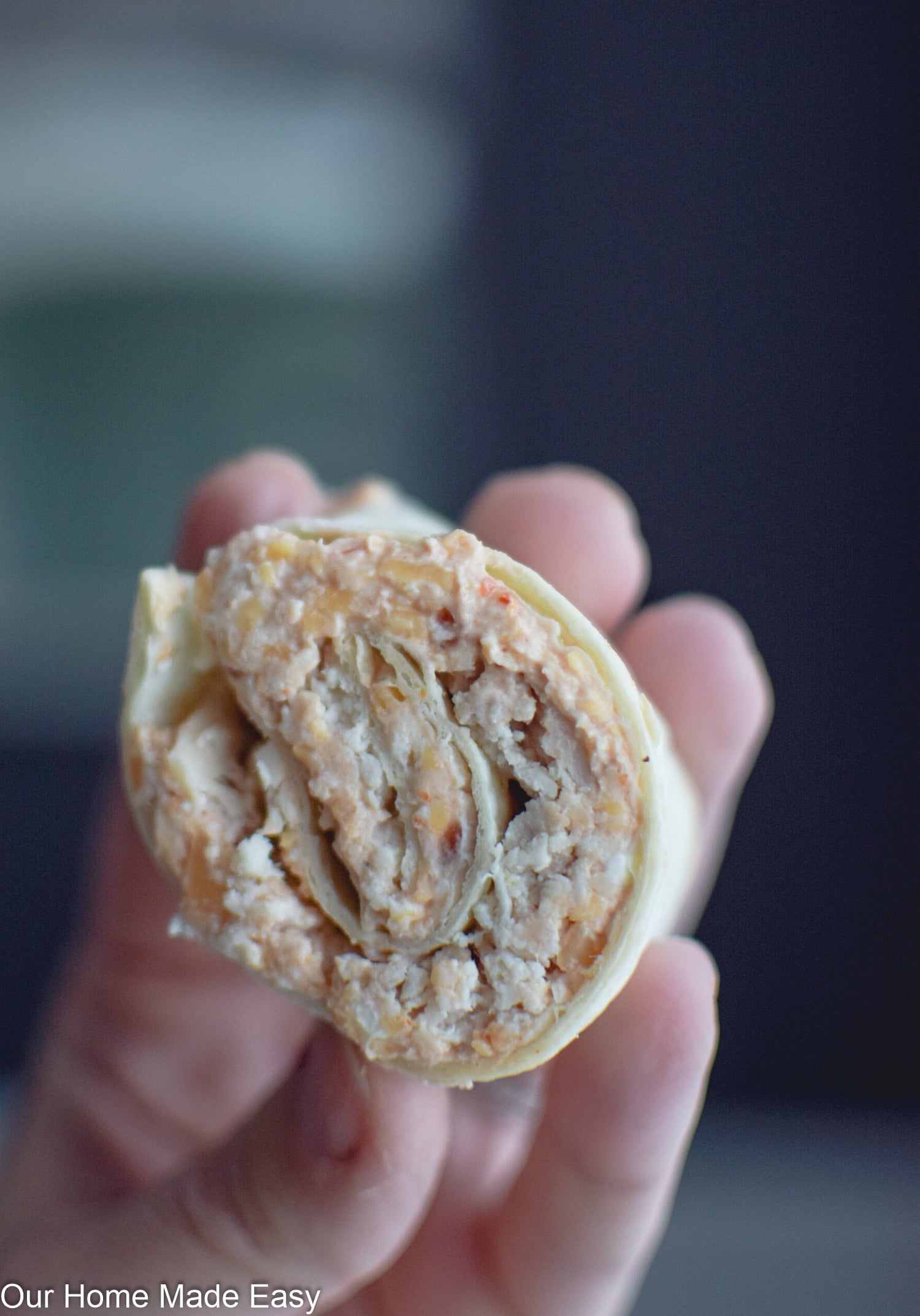 chicken tortilla roll ups cut in half to show filling.
