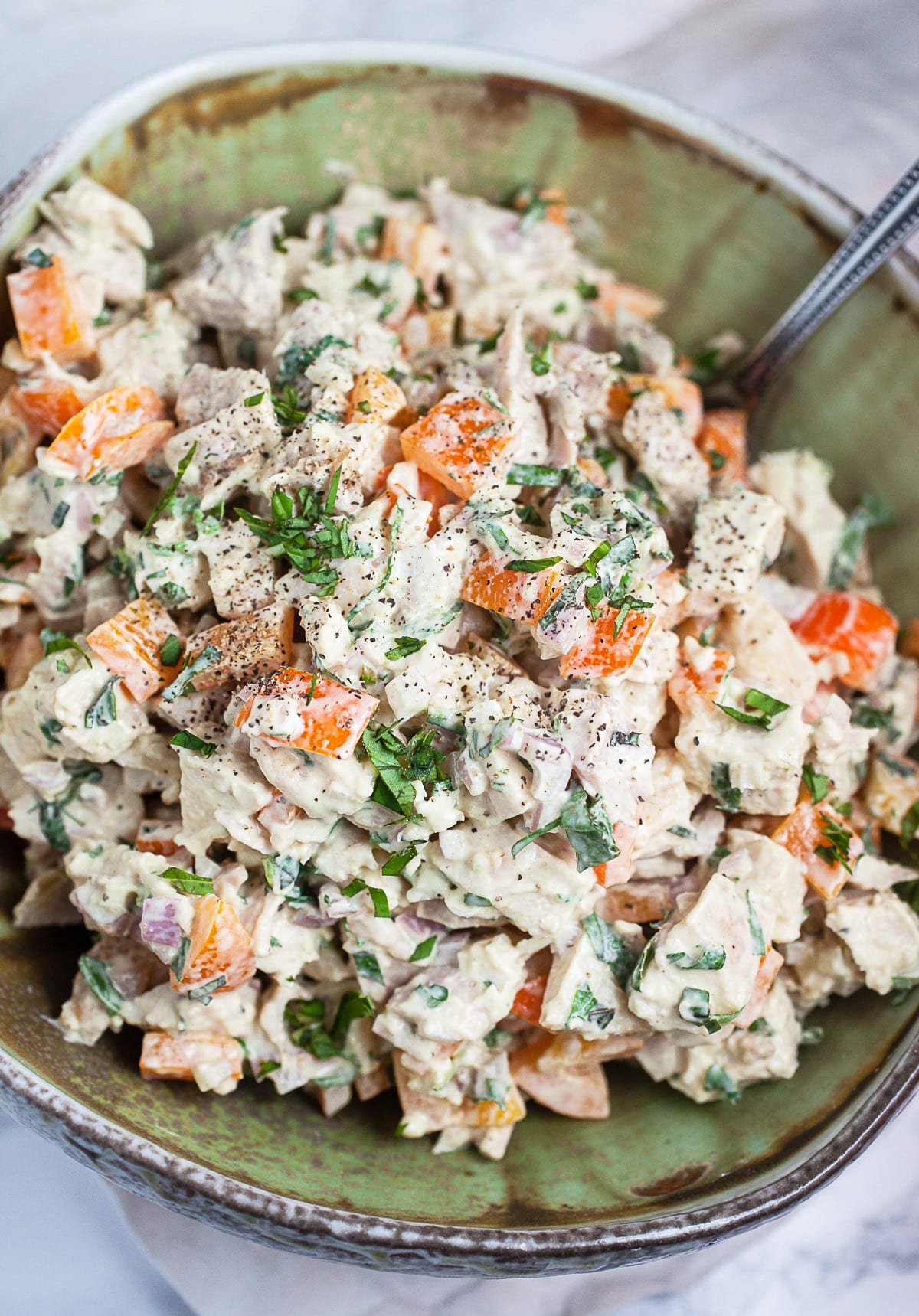 lemon basil chicken salad in a green pottery bowl
