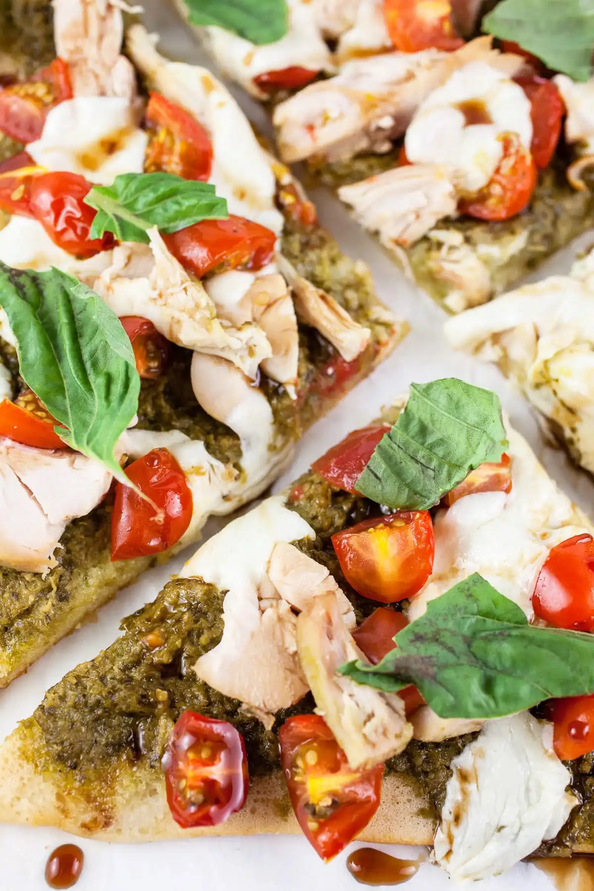 Chicken pesto flatbread pizza up close.