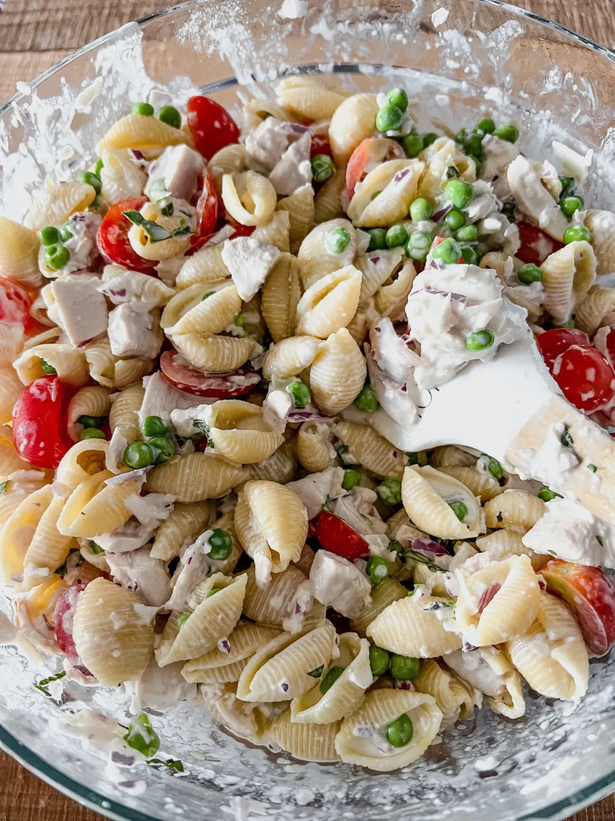 cold rotisserie chicken pasta salad with peas and grape tomatoes.