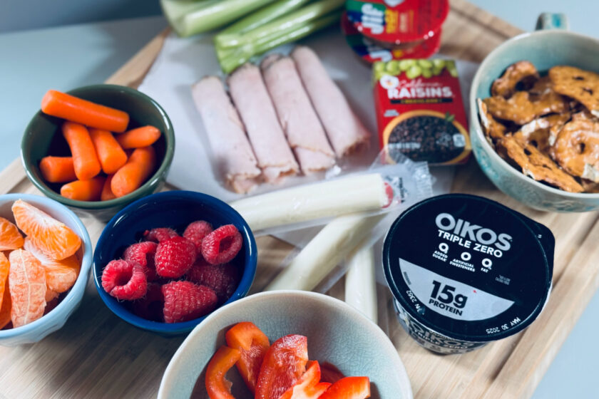 easy snack platter for kids on cutting board with berries, veggies, lunch meat and more.