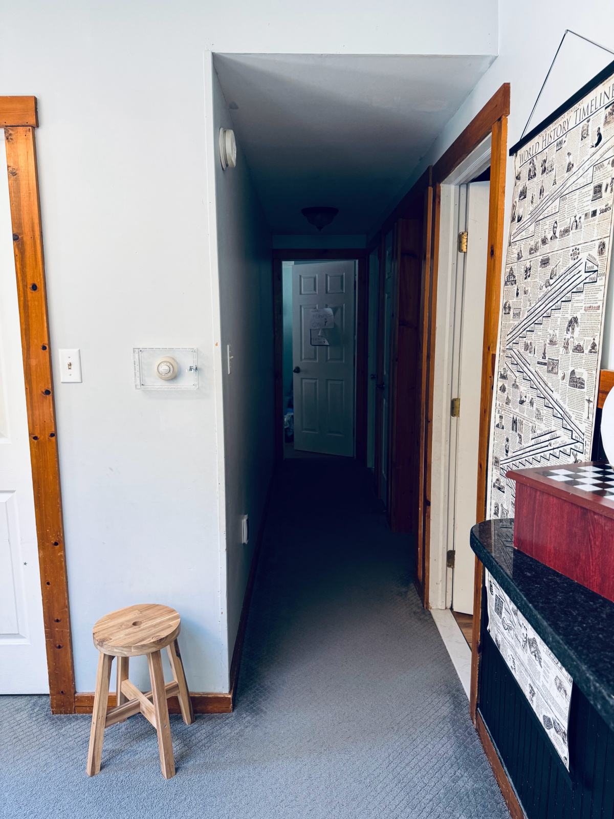 hallway heading ending with bedroom door slightly ajar.