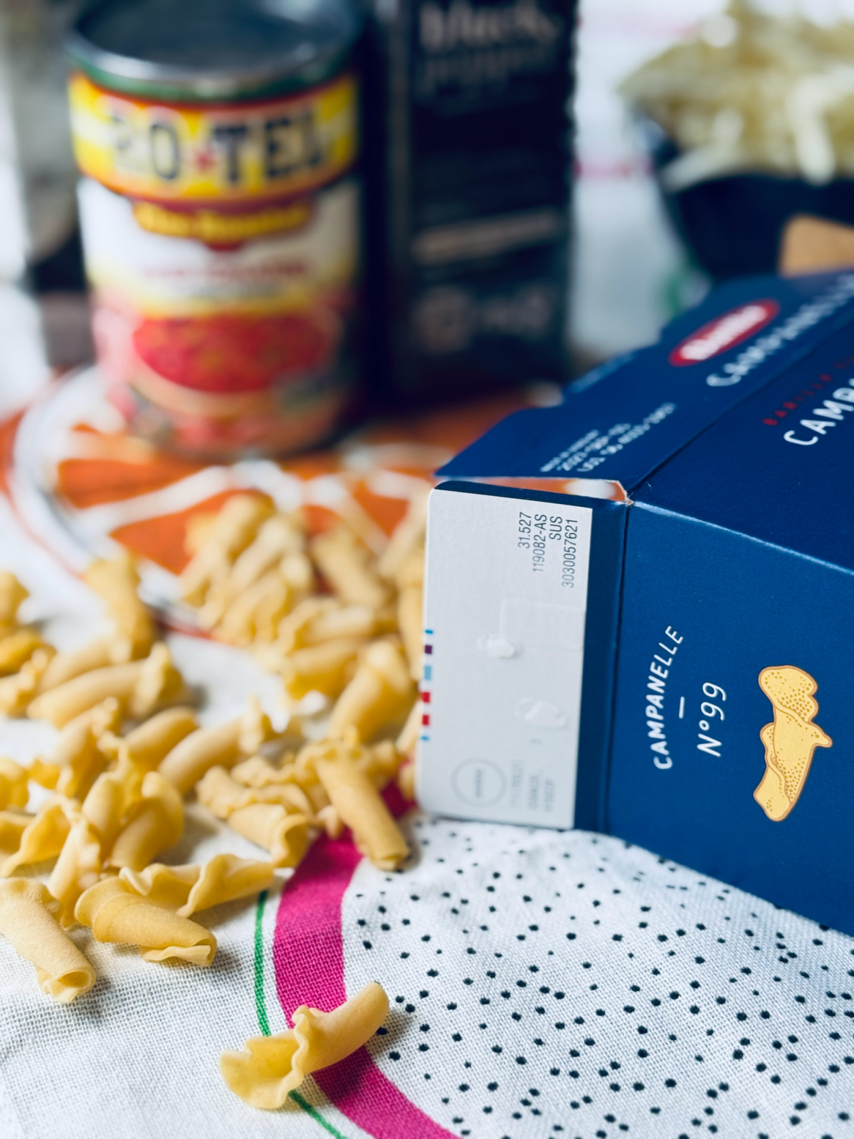 Barilla's Campanelle pasta box spilled with Campanelle noodles in focus.