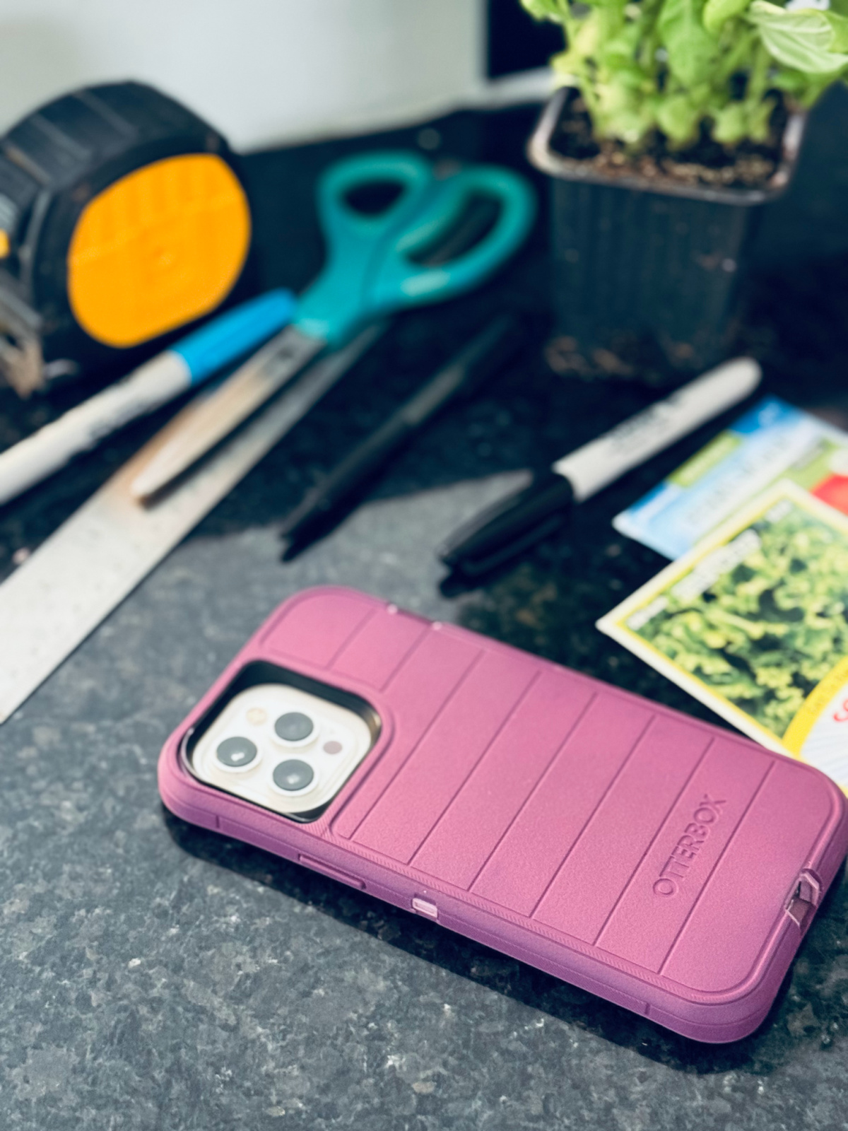 purple iphone upside down on counter.