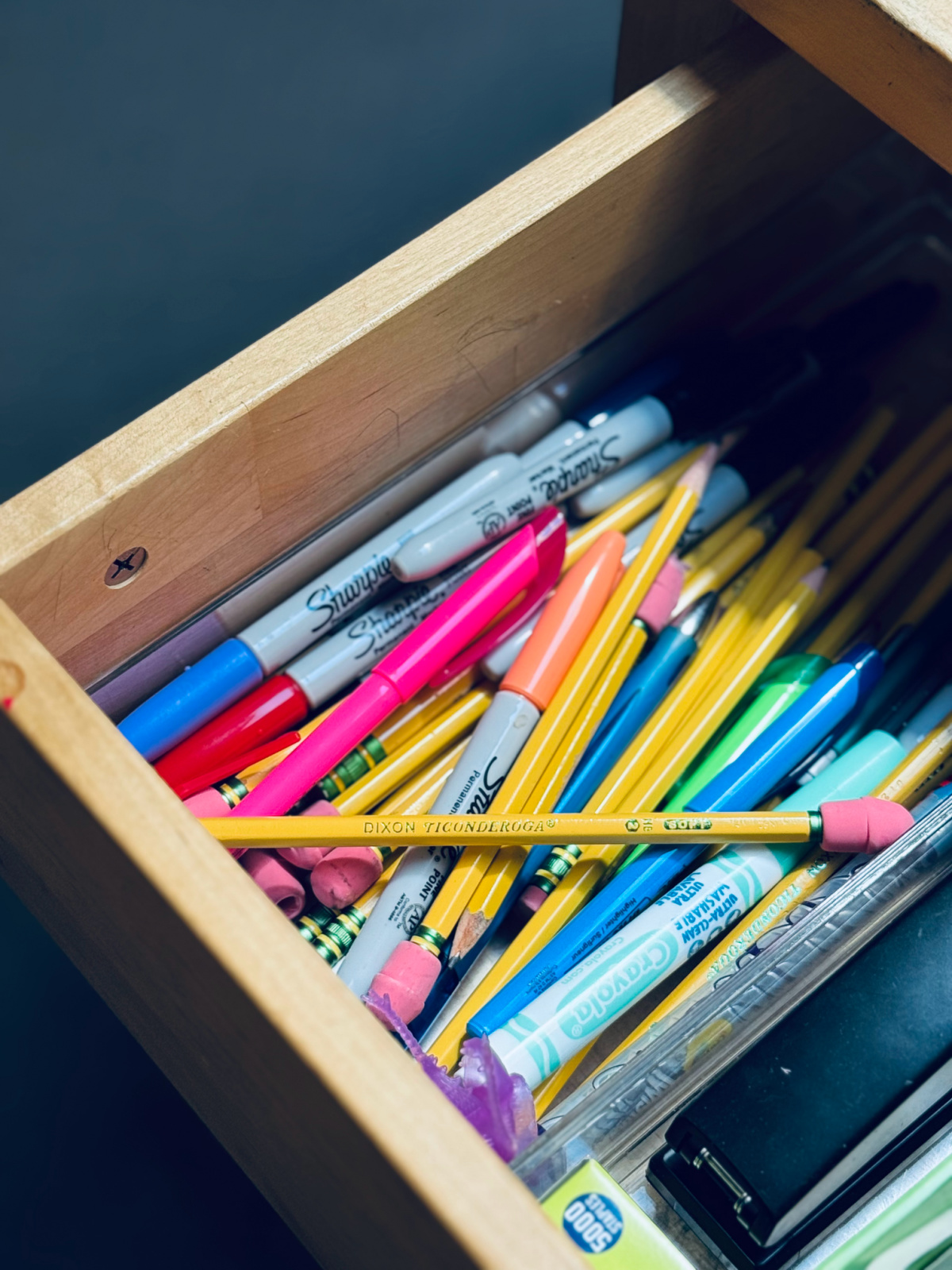 Dixon Ticonderoga Pencil close up with eraser cap in drawer with other markers and writing utensils.