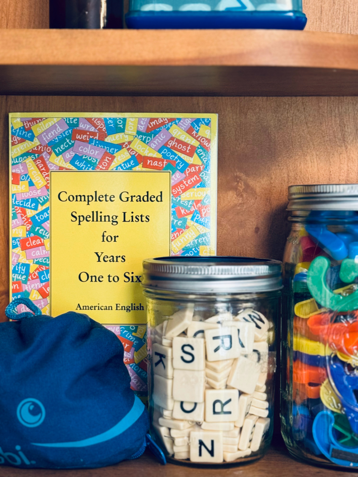 book complete graded spelling lists with jars of letters.