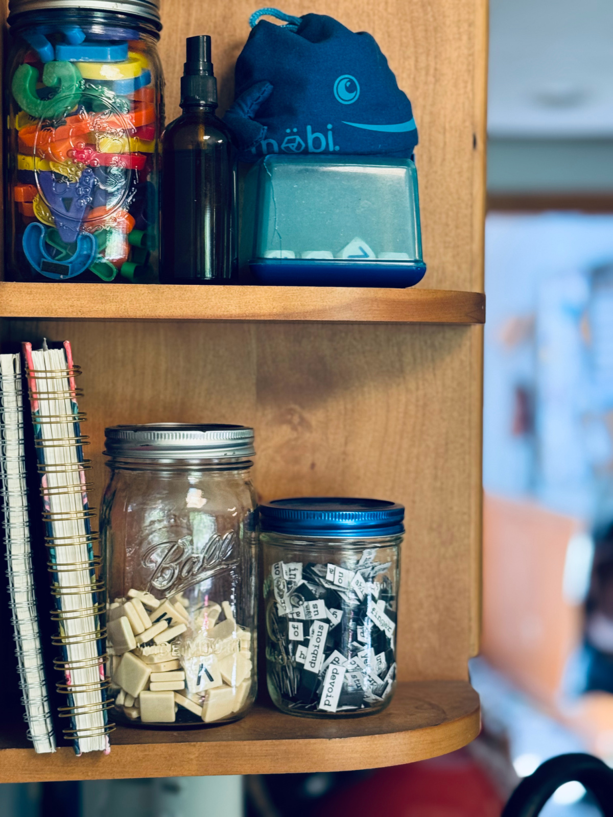 shelves with jars of letter and number tiles.