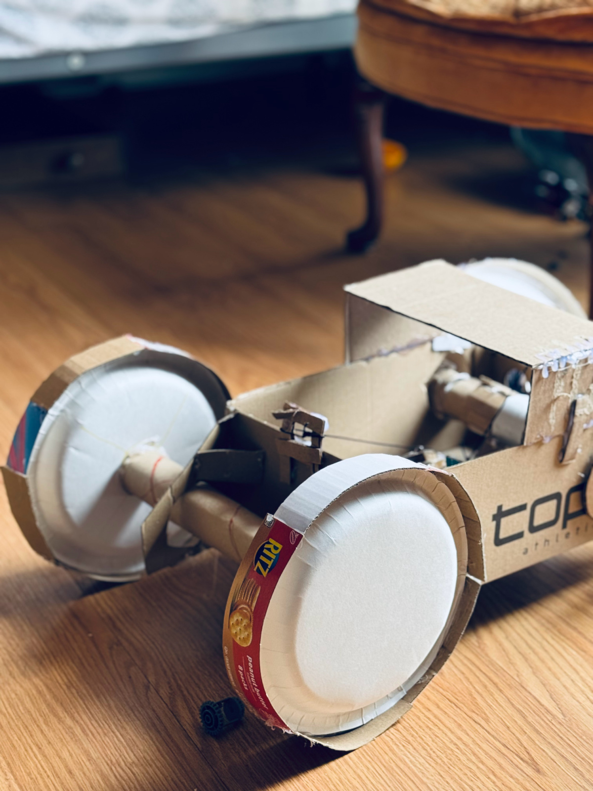 cardboard car built by unschooled child.