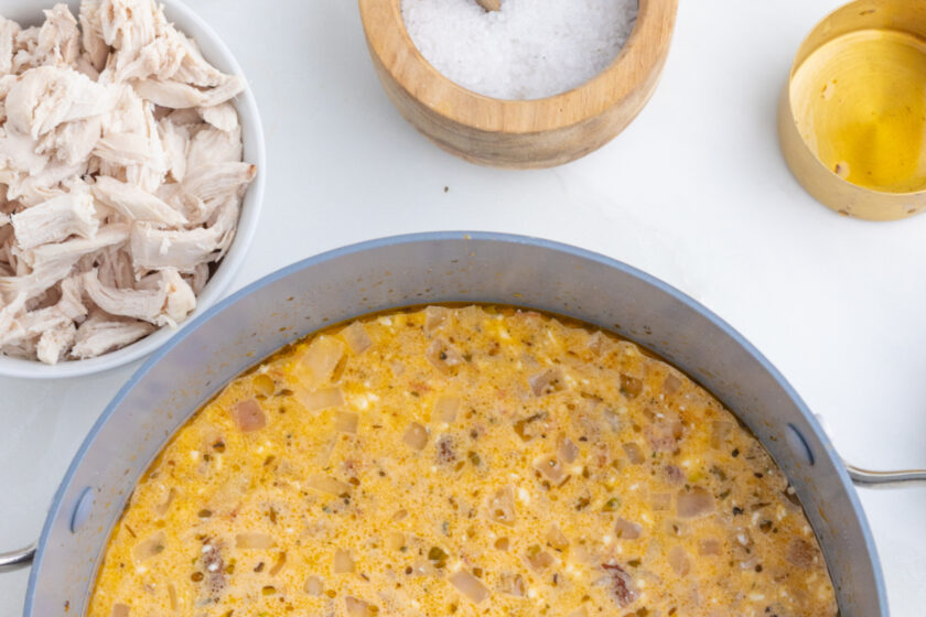 pot of soup with ingredients surrounding it.