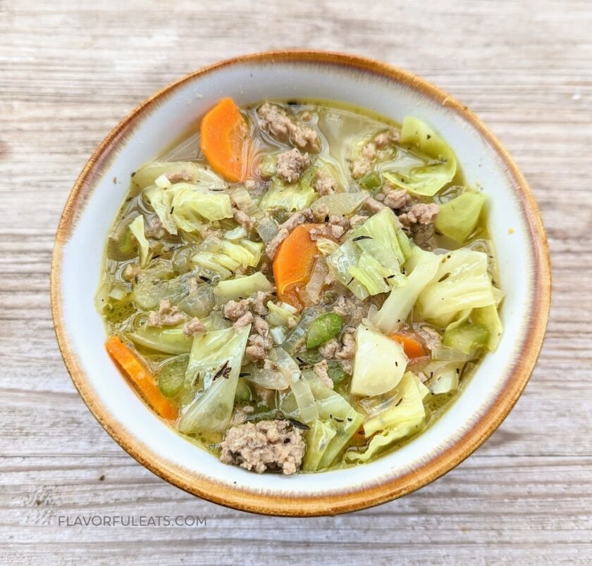 ground turkey cabbage soup in pottery bowl on table.
