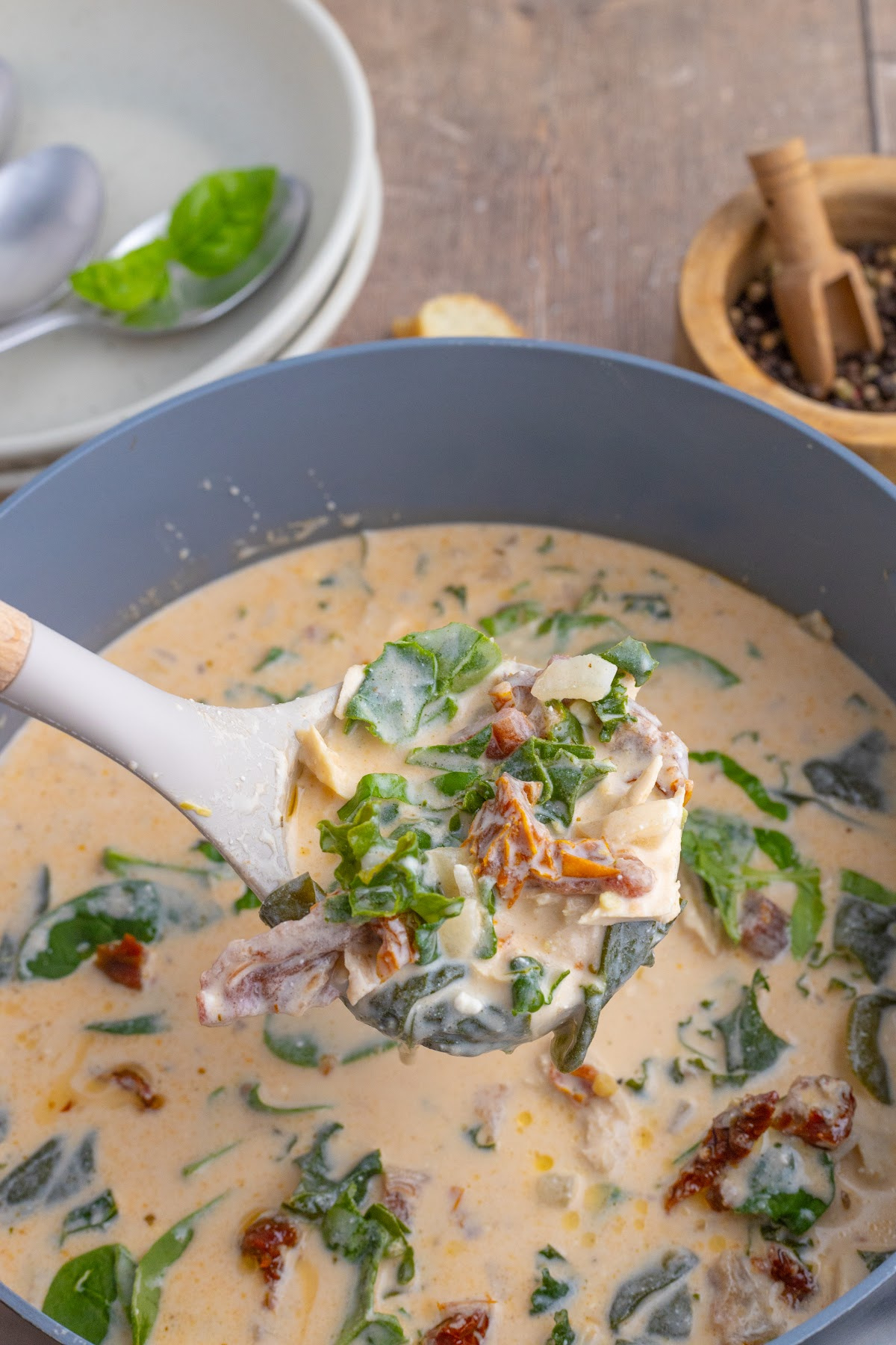 marry me chicken soup in stockpot with ladle showing close up.