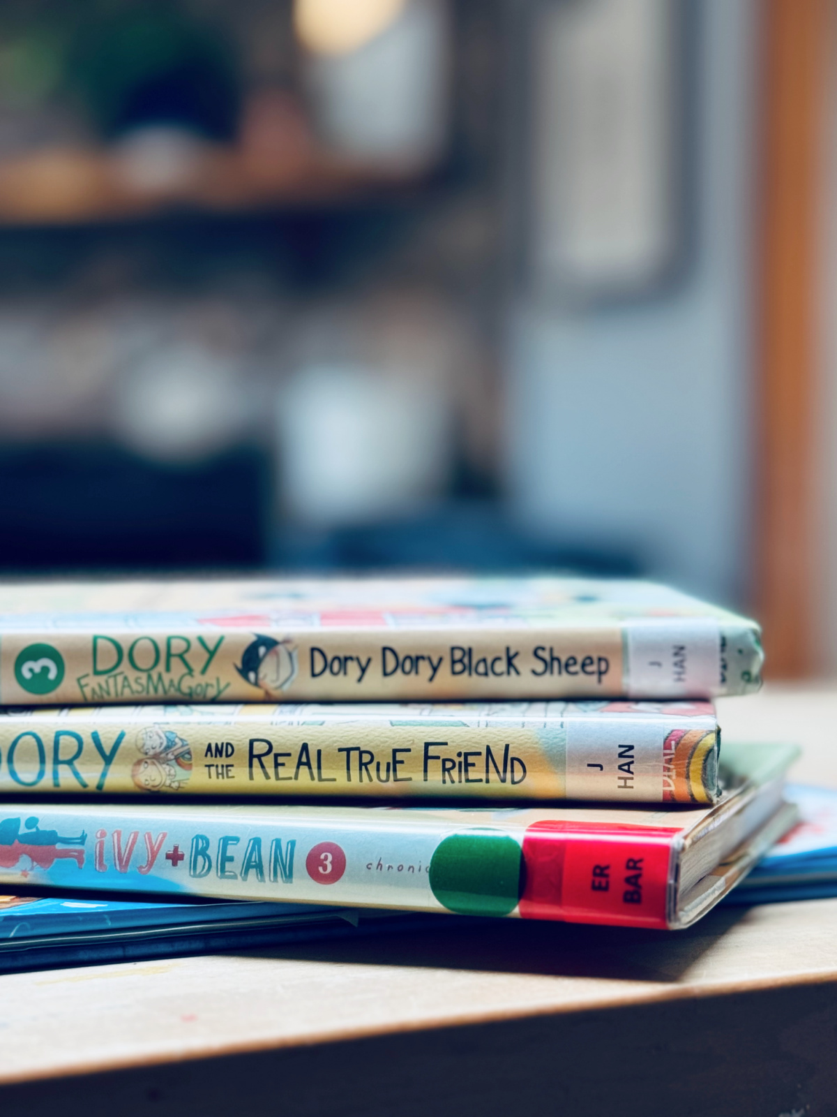 library books with library shelf denotations in focus.