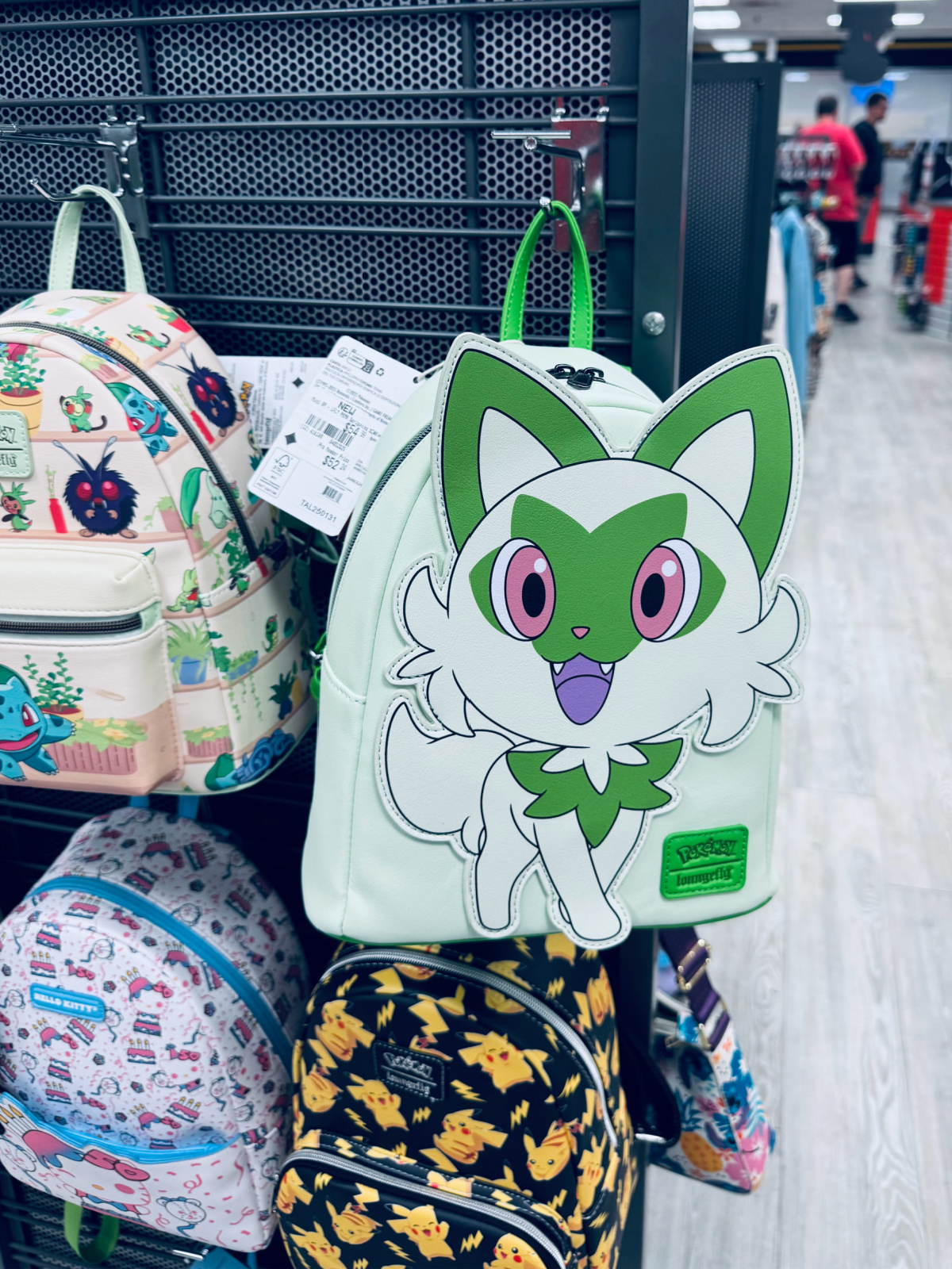 small purse-sized backpacks on rack at Gamestop.