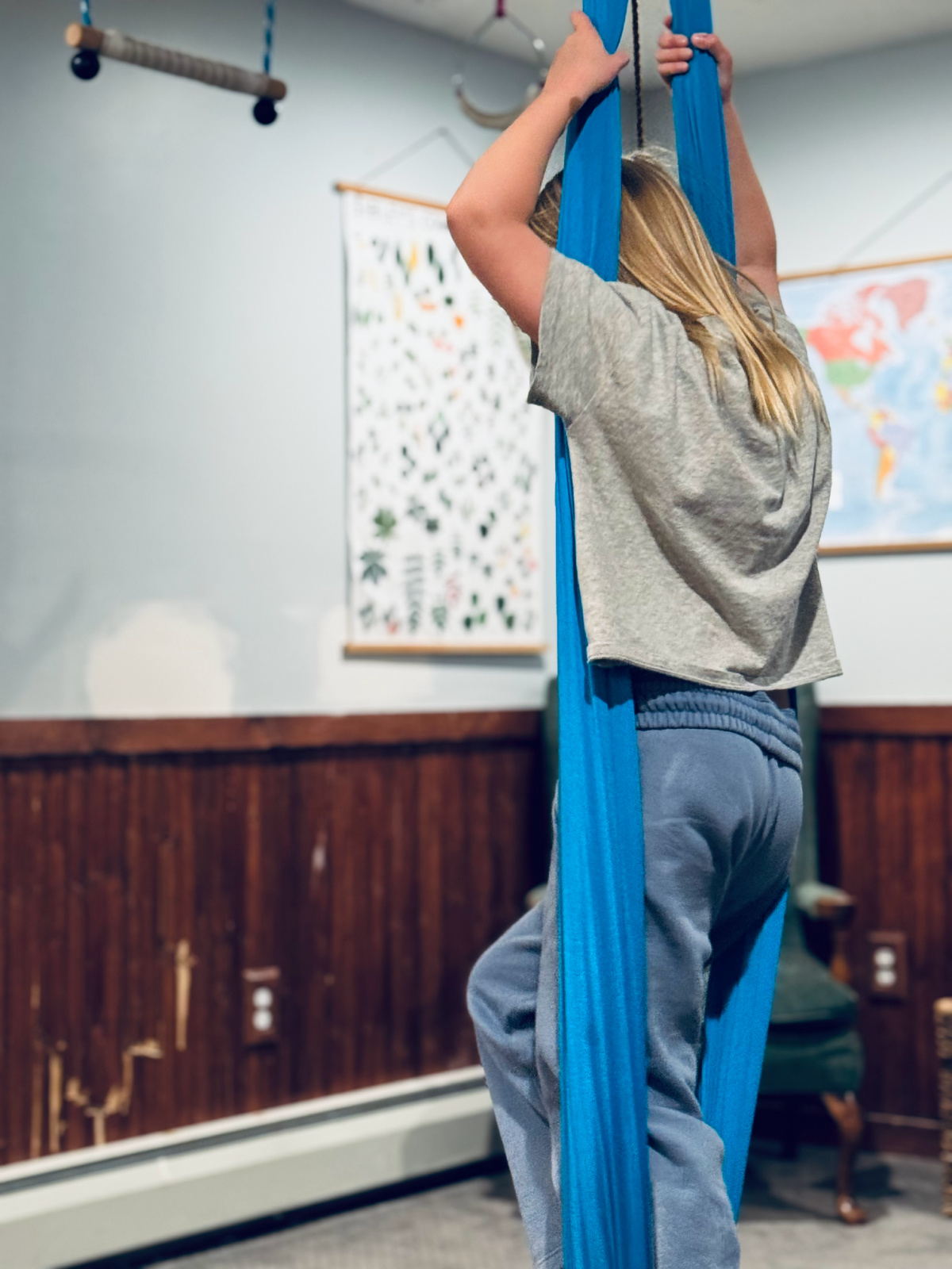 child standing in sensory swing she received as a Christmas gift.