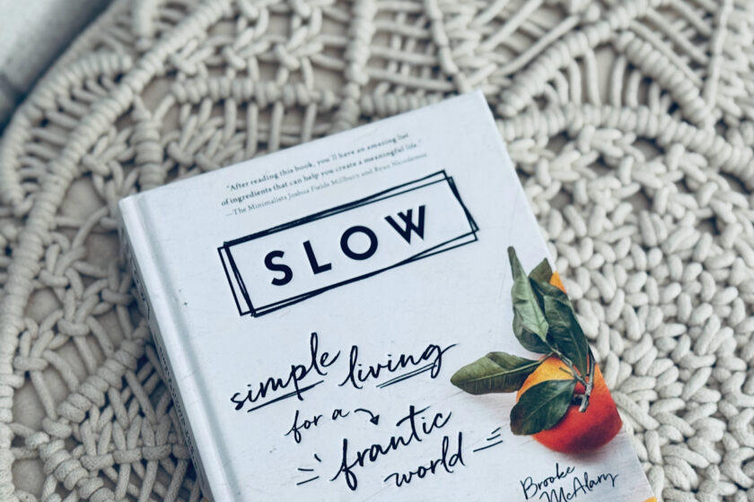 book cover Slow by Brooke McAlary on crocheted ottoman.