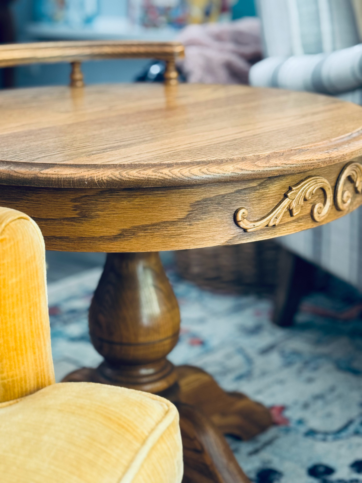 second-hand round wooden table in between two chairs.