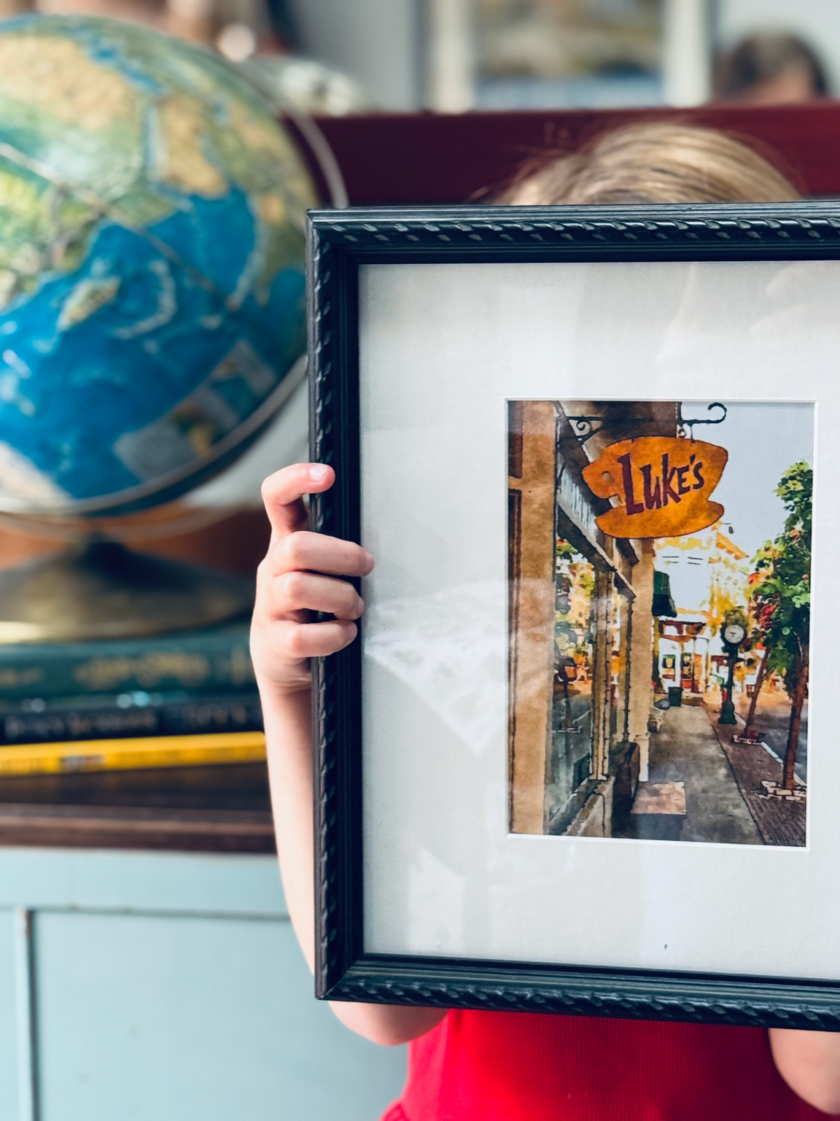 Gilmore Girls Luke diner wall art in black frame in focus.